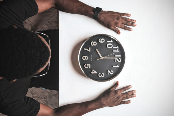 black clock on white desk 