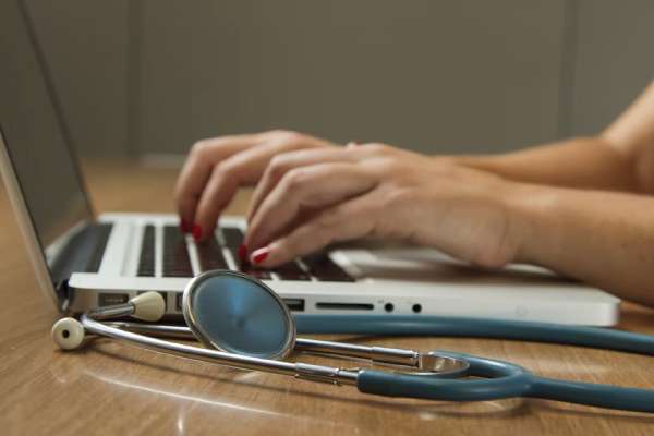 Person on Computer with Stethoscope